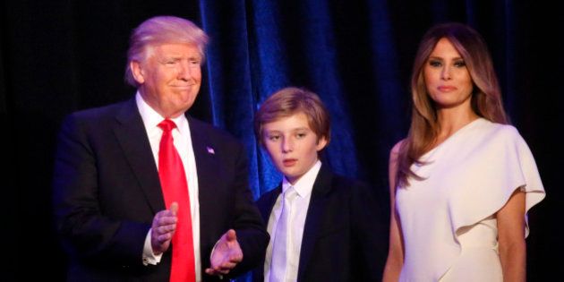 Republican U.S. president-elect Donald Trump stands with his son Barron (C) and wife Melania at his election night rally in Manhattan, New York, U.S., November 9, 2016. REUTERS/Carlo Allegri
