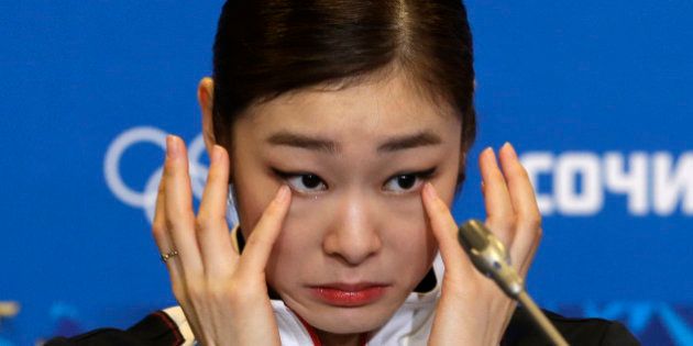 Yuna Kim of South Korea wipes her face as she attends a news conference following the women's free skate figure skating finals at the Iceberg Skating Palace during the 2014 Winter Olympics, Thursday, Feb. 20, 2014, in Sochi, Russia. (AP Photo/Darron Cummings)