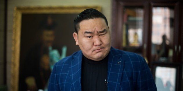 To go with Mongolia-Japan-wrestling-sumo,FEATURE by Kelly Olsen This photo taken on February 11, 2015 shows Dagvadorj Dolgorsurengiin better known as former sumo wrestler 'yokozuna' or grand champion, Asashoryu, posing for a picture in his office. The slapping sound of colliding flesh reverberates through a basement in Mongolia's capital, as Tsogt-Erdeniin Mendsaikhan hones fighting skills in pursuit of his dream -- sumo wrestling in Japan. The teenager is inspired by Hakuho, a Mongolian grand champion, or 'yokozuna', who in January broke a more than four decade-old record when he won his 33rd Emperor's Cup, awarded to the champion of the bi-monthly top tournament. AFP PHOTO / JOHANNES EISELE (Photo credit should read JOHANNES EISELE/AFP/Getty Images)