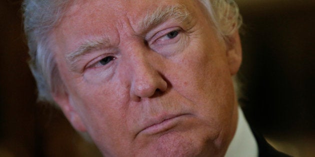 U.S. President-elect Donald Trump listens to questions from reporters in the lobby at Trump Tower in New York, U.S., January 9, 2017. REUTERS/Mike Segar