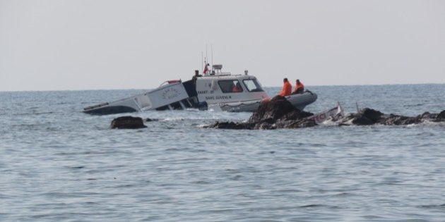 CANAKKALE, TURKEY - JANUARY 30: A boat, which was carrying refugees, is seen in the Aegean sea after it sank off close to coast of Ayvacik district, Canakkale, Turkey on January 30, 2016. At least 33 people, have drowned off the Aegean Sea coast of Turkey (Photo by Hanife Erdinc/Anadolu Agency/Getty Images)