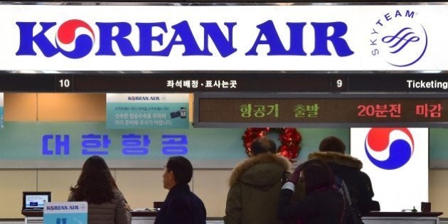 Travelers are seen at the Korean Air ticketing desk at Gimpo airport in Seoul on December 16, 2014. South Korea said it could fine Korean Air up to 2 million USD after the daughter of its chief executive delayed a flight by throwing a tantrum over some nuts. AFP PHOTO / JUNG YEON-JE (Photo credit should read JUNG YEON-JE/AFP/Getty Images)