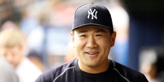 Jul 30, 2016; St. Petersburg, FL, USA; New York Yankees pitcher Masahiro Tanaka (19) smiles and looks on during the third inning against the Tampa Bay Rays at Tropicana Field. Mandatory Credit: Kim Klement-USA TODAY Sports