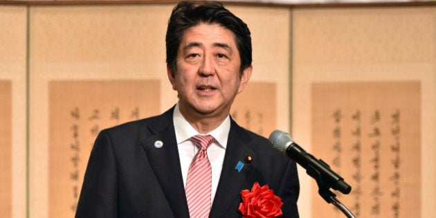 Japanese Prime Minister Shinzo Abe delivers a speech at a ceremony to mark the 50th anniversary of normalizing relations between Japan and South Korea, hosted by South Korean Embassy in Tokyo Monday, June 22, 2015. South Korean Foreign Minister Yun Byung-se attended the ceremony. (Yoshikazu Tsuno/Pool Photo via AP)