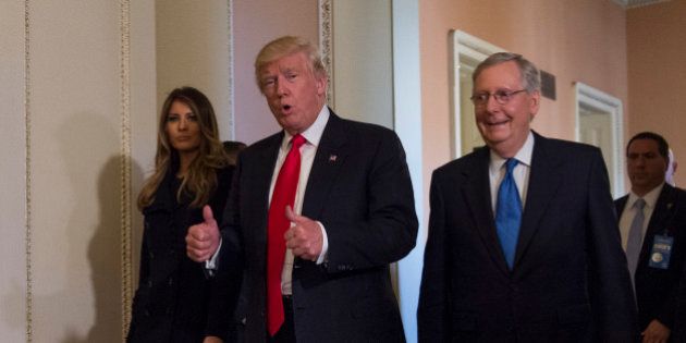 President-elect Donald Trump, flanked by his wife Melania and Senate Majority Leader Mitch McConnell of Ky., gives a thumbs-up while walking on Capitol Hill in Washington, Thursday, Nov. 10, 2016, after their meeting. (AP Photo/Molly Riley)
