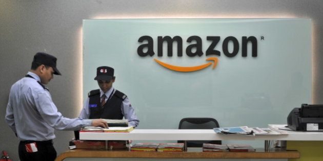 Security guards stand at the reception desk of the Amazon India office in Bengaluru, India, August 14, 2015. E-commerce giant Amazon.com is taking lessons learnt from its daily battles with India's choked roads and cramped cities to some of its largest developed markets, exporting a model of cheaper deliveries and reduced warehousing costs. Picture taken August 14, 2015. To match AMAZON.COM-INDIA/LOGISTICS REUTERS/Abhishek N. Chinnappa