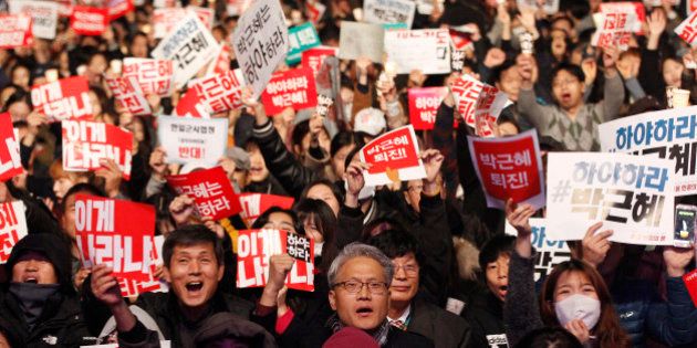 FILE - In this Saturday, Nov. 5, 2016, file photo, South Korean protesters shout slogans during a rally calling for South Korean President Park Geun-hye to step down in downtown Seoul, South Korea. In only a few days, South Korea's biggest scandal in years has done what six decades of diplomacy and bloodshed couldnât, uniting the rival Koreas, at least in one area: indignation against South Koreaâs leader. North Korean propaganda regularly attacks South Korean President Park Geun-hye. Many South Koreans now seem to be reaching Pyongyang levels of fury over an investigation into whether Park allowed a longtime confidante to manipulate her administration from the shadows. (AP Photo/Ahn Young-joon, File)