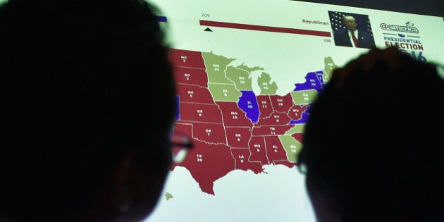 Indonesians observe a US electoral map as they wait for the results of the country's presidential election during an event organised by the US Embassy, at a mall in Jakarta on November 9, 2016. Donald Trump's stunning performance in the US presidential election triggered shock and angst in Asia, where observers fretted over the implications for everything from trade to human rights and climate change. / AFP / BAY ISMOYO (Photo credit should read BAY ISMOYO/AFP/Getty Images)