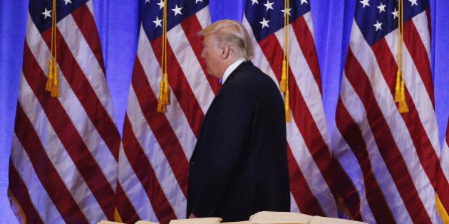 U.S. President-elect Donald Trump walks past a pile of papers during a news conference in the lobby of Trump Tower in Manhattan, New York City, U.S., January 11, 2017. REUTERS/Lucas Jackson