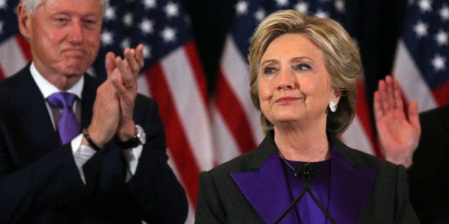 Democratic presidential candidate Hillary Clinton, with her husband, former U.S. President Bill Clinton, (L), receives applause at her concession speech to President-elect Donald Trump in New York, U.S., November 9, 2016. REUTERS/Carlos Barria TPX IMAGE OF THE DAY