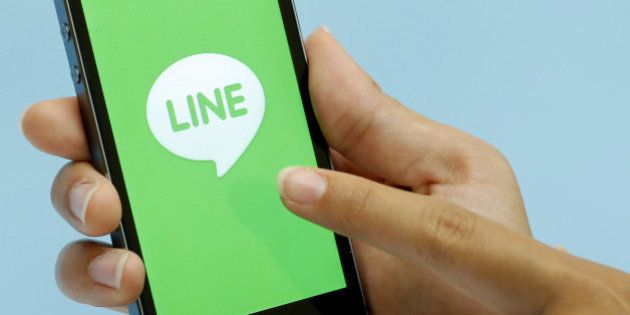 The loading page for a messaging and calling service application operated by Line Corp., controlled by Naver Corp., is displayed on an Apple Inc. iPhone 5s for a photograph during an event for the company's new services in Tokyo, Japan, on Wednesday, Aug. 27, 2014. Line will offer a group discount service from Aug. 28 in Japan, Takeshi Shimamura, an executive director at the company, told reporters in Tokyo today. Photographer: Kiyoshi Ota/Bloomberg via Getty Images