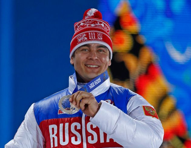 Silver medalist Albert Demchenko of Russia holds up his medal during the medal ceremony for the men's singles luge event at the Sochi 2014 Winter Olympics February 10, 2014. REUTERS/Shamil Zhumatov (RUSSIA - Tags: OLYMPICS SPORT LUGE)