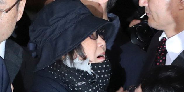 Choi Soon-sil, center left, a cult leader's daughter with a decades-long connection to President Park Geun-hye, is surrounded by prosecutor's officers and media upon her arrival at the Seoul Central District Prosecutors' Office in Seoul, South Korea, Monday, Oct. 31, 2016. South Korea is hoping for answers Monday about its biggest scandal in years. At the center is Choi Soon-sil. Media speculation claims that Choi, who has no official ties to the administration, may have had a major role in government affairs by pulling strings from the shadows while exploiting her relationship with Park for money and favors. (AP Photo/Lee Jin-man)