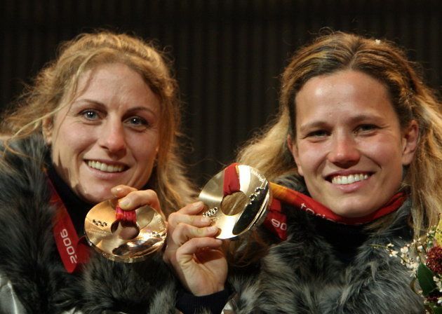 Bronze medallists Gerda Weissensteiner(R) and Jennifer Issaco of Italy celebrate after receiving their medals for the bobsleigh women's two man event at the Torino 2006 Winter Olympic Games in Turin, Italy February 22, 2006.