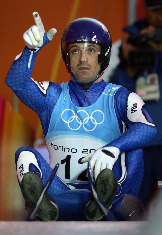 Wilfried Huber of Italy gestures during an official men luge training run for the Torino 2006 Winter Olympic Games competition in Cesana Pariol, Italy, February 8, 2006. REUTERS/Jean-Paul Pelissier