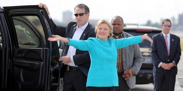 FOR STORY MOVING SUNADY NOV 6TH 0600EDT/1100GMTU.S. Democratic presidential candidate Hillary Clinton reacts before boarding her campaign plane at Miami international airport in Miami, Florida, U.S., October 26, 2016. REUTERS/Carlos Barria/File Photo