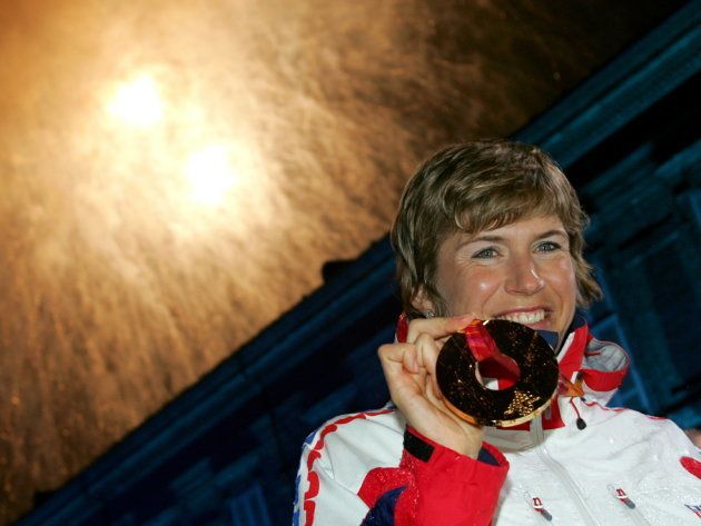 Gold medallist Katerina Neumannova of the Czech Republic celebrates after receiving her medal for winning the women's 30km cross country race at the Torino 2006 Winter Olympic Games in Turin, Italy February 24, 2006.