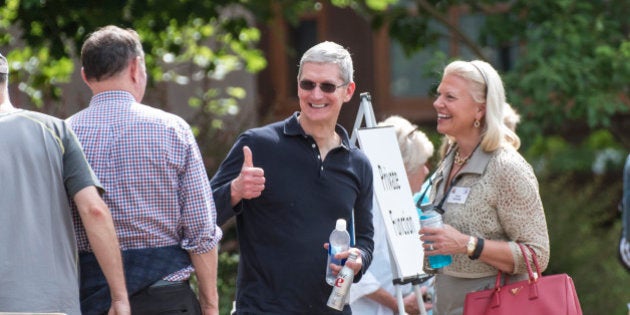 Tim Cook, chief executive officer of Apple Inc., center, gestures to Donald Graham, former chairman and chief executive officer of The Washington Post Co., as Virginia 'Ginni' Rometty, chief executive officer of International Business Machines Corp. (IBM), looks on after a morning session during the Allen & Co. Media and Technology Conference in Sun Valley, Idaho, U.S., on Wednesday, July 8, 2015. Billionaires, chief executive officers, and leaders from the technology, media, and finance industries gather this week at the Idaho mountain resort conference hosted by investment banking firm Allen & Co. Photographer: David Paul Morris/Bloomberg via Getty Images