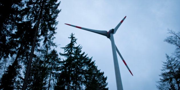 MARKT BERATZHAUSEN, GERMANY - OCTOBER 29: A wind turbine Enercon 101 is located in the forest Brenntenberg behind trees on October 29, 2013 in Markt Beratzhausen, Germany.(Photo by Michael Gottschalk/Photothek via Getty Images)