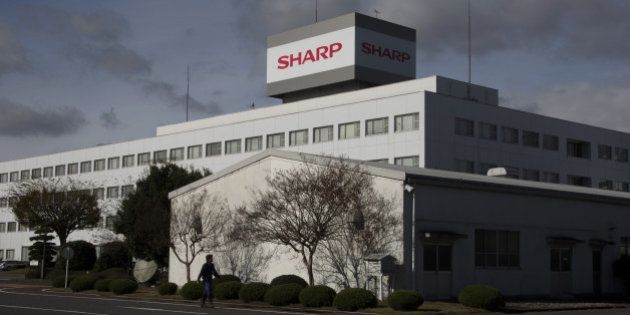 A man walks past the Sharp Corp. plant in Yaita, Tochigi Prefecture, Japan, on Thursday, Nov. 19, 2015. Shares rose as much as 7.1 percent in early Tokyo trading Nov. 20, rising for the second day, bringing the biggest two-day gain since July 3. Photographer: Tomohiro Ohsumi/Bloomberg via Getty Images