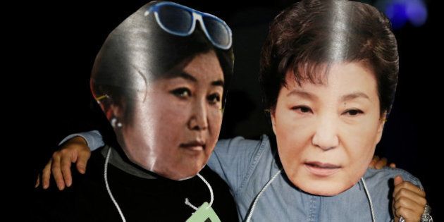 Protesters wearing cut-out of South Korean President Park Geun-hye (R) and Choi Soon-sil attend a protest denouncing President Park Geun-hye over a recent influence-peddling scandal in central Seoul, South Korea, October 27, 2016. REUTERS/Kim Hong-Ji