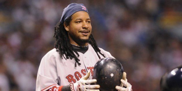 ST PETERSBURG, FL - July 2: Designated hitter Manny Ramirez #24 of the Boston Red Sox smiles after ducking from an inside pitch against the Tampa Bay Rays July 2, 2008 at Tropicana Field in St. Petersburg, Florida. (Photo by Al Messerschmidt/Getty Images)