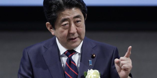 Shinzo Abe, Japan's prime minister, gestures as he speaks at business federation Nippon Keidanren in Tokyo, Japan on Monday, Dec. 26, 2016. During the meeting, Bank of Japan Governor Haruhiko Kuroda said that it's necessary to achieve 2 percent inflation in this round of monetary easing to ensure Japan never falls back into deflation. Photographer: Kiyoshi Ota/Bloomberg via Getty Images