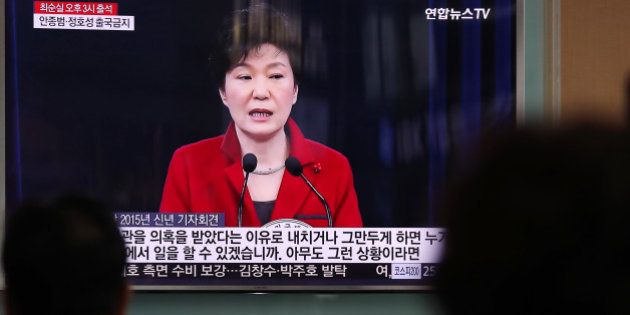 People watch a television screen showing an image of Park Geun Hye, South Korea's president, during a news broadcast at Seoul Station in Seoul, South Korea, on Monday, Oct. 31, 2016. As Park's popularity plummets, members of her own party are publicly demanding action to staunch the bleeding from an influence-peddling scandal. Photographer: SeongJoon Cho/Bloomberg via Getty Images
