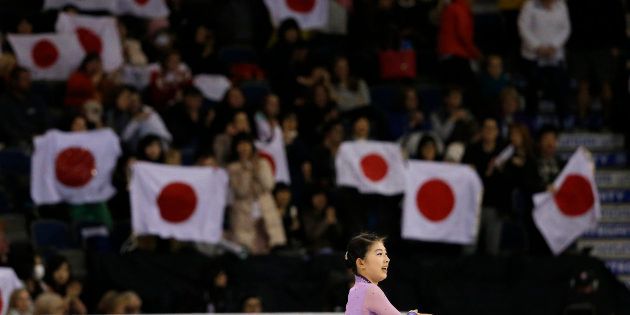 Fans wave Japanese flags as Yuka Nagai of Japan finishes her performance during the Ladies Short program at Skate Canada International in Lethbridge, Alberta October 30, 2015. Fifty-six Olympic and world championship athletes are competing in the event, which is the second of six stops on the International Skating Union (ISU) Grand Prix of Figure Skating Series. REUTERS/Jim Young