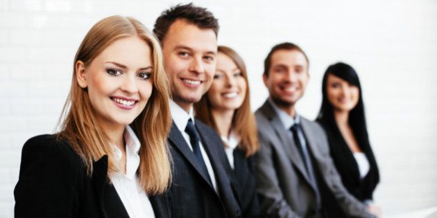 Group of happy business people sitting in a row