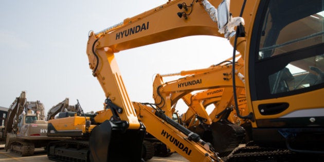 Hyundai Heavy Industries Co. excavators stand parked at the Hyundai Heavy Industries Co. plant in Ulsan, South Korea, on Wednesday, July 29, 2015. Hyundai Heavy is one of South Korea's Big Three shipbuilders. Photographer: SeongJoon Cho/Bloomberg via Getty Images