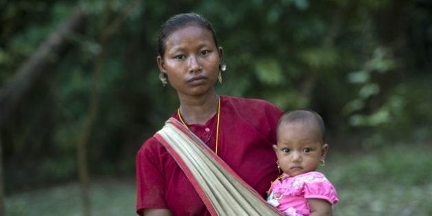 A displaced resident, member of the Myo ethnic group, carries her child at a Buddhist monastery in Kantharyar village at Maungdaw located in Rakhine State near the Bangladesh border on October 15, 2016.A Pakistani Taliban-trained militant leader was behind deadly attacks in the north of Myanmar's Rakhine state that have sparked a military crackdown and sent thousands of terrified residents fleeing the area, Myanmar's president said on October 14. / AFP / YE AUNG THU (Photo credit should read YE AUNG THU/AFP/Getty Images)