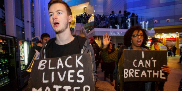 LONDON, UNITED KINGDOM - DECEMBER 10: Hundreds of people demonstrate outside White City Westfield Shopping Centre in London, England on December 10, 2014 during a protest after two grand juries decided not to indict the police officers involved in the deaths of Michael Brown in Ferguson, Mo. and Eric Garner in New York, N.Y. (Photo by Tolga Akmen/Anadolu Agency/Getty Images)