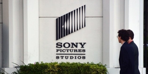 Pedestrians walk past an exterior wall to Sony Pictures Studios in Los Angeles, California on December 4, 2014, a day after Sony Pictures denounced a 'brazen' cyber attack it said netted a 'large amount' of confidential information, including movies as well as personnel and business files, But downplaying a report that North Korea was behind the attack, saying it did not yet know the full extent of the 'malicious' security breach. AFP PHOTO/Frederic J. BROWN (Photo credit should read FREDERIC J. BROWN/AFP/Getty Images)