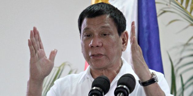 Philippine President Rodrigo Duterte gestures while answering questions during a news conference upon his arrival from a state visit in Japan at the Davao International Airport in Davao city, Philippines October 27, 2016. REUTERS/Lean Daval Jr