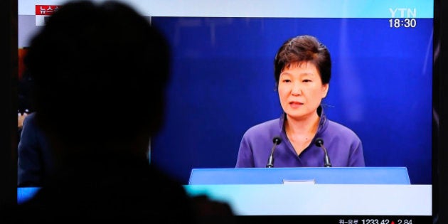 A man watches a TV screen showing the news program about South Korean President Park Geun-hye's apology, at the Seoul Railway Station in Seoul Tuesday, Oct. 25, 2016. South Korea's president offered a surprise public apology on Tuesday after acknowledging her close ties to a mysterious woman at the center of a corruption scandal. (AP Photo/Lee Jin-man)