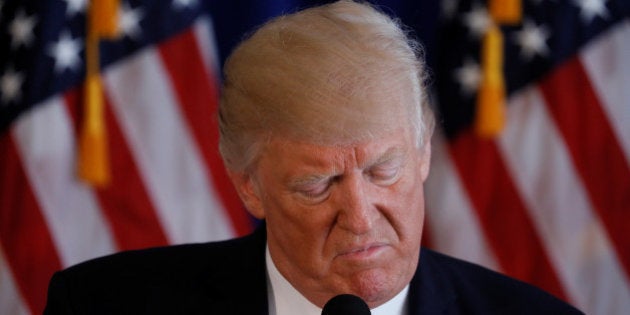 U.S. President Donald Trump reads from a prepared statement as he delivers remarks on the protests in Charlottesville, Virginia, from his golf estate in Bedminster, New Jersey U.S., August 12, 2017. REUTERS/Jonathan Ernst