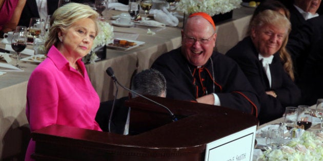 U.S. presidential nominee Hillary Clinton delivers remarks as Republican U.S. presidential nominee Donald Trump smiles (R) during the Alfred E. Smith Memorial Foundation dinner in New York, U.S. October 20, 2016. REUTERS/Carlos Barria