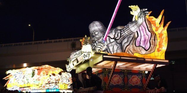 Students carry the Star Wars Sith Nebuta float featuring Darth Maul, Sheev Palpatine and Darth Vader during the eve of the Nebuta summer festival in Aomori city, Aomori prefecture on August 1, 2015. Four Star Wars Nebuta floats were introduced to commemorate the Star Wars series new movie, 'Star Wars: The Force Awakens' which will show in world wide from December this year. AFP PHOTO / TOSHIFUMI KITAMURA (Photo credit should read TOSHIFUMI KITAMURA/AFP/Getty Images)