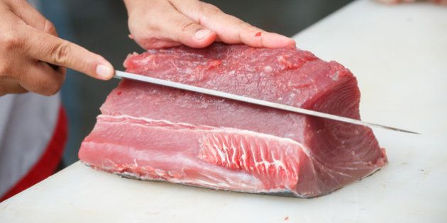 cutting tuna on a white table