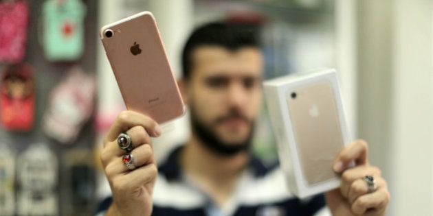 A Palestinian man holds Apple's new iPhone 7 at a mobile phone store in Gaza City on September 22, 2016. Apple's new iPhone 7 is selling well in the Gaza Strip despite inflated prices. (Photo by Majdi Fathi/NurPhoto via Getty Images)
