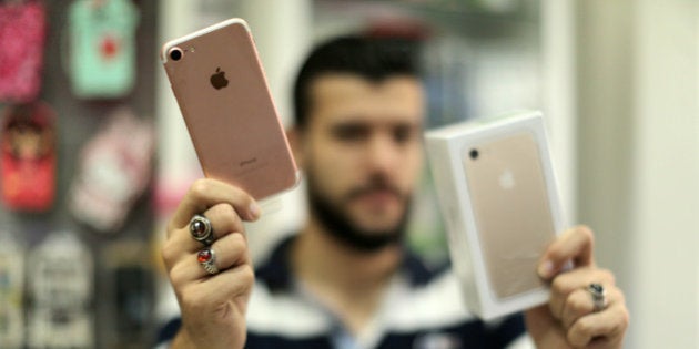 A Palestinian man holds Apple's new iPhone 7 at a mobile phone store in Gaza City on September 22, 2016. Apple's new iPhone 7 is selling well in the Gaza Strip despite inflated prices. (Photo by Majdi Fathi/NurPhoto via Getty Images)