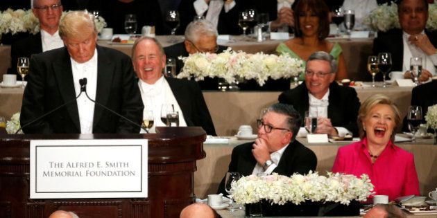 Democratic U.S. presidential nominee Hillary Clinton (R) laughs at a joke by Republican U.S. presidential nominee Donald Trump (L) at the Alfred E. Smith Memorial Foundation dinner in New York, U.S. October 20, 2016. REUTERS/Jonathan Ernst