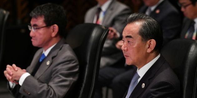 China's Foreign Minister Wang Yi (R) and Japan's Foreign Minister Taro Kono (L) listen to the opening remarks during the 18th ASEAN Plus Three Foreign Ministers Meeting, part of the Association of Southeast Asian Nations (ASEAN) regional securiy forum in Manila on August 7, 2017.The annual forum, hosted by the Association of Southeast Asian Nations (ASEAN), brings together the top diplomats from 26 countries and the European Union for talks on political and security issues in Asia-Pacific. / AFP PHOTO / POOL / MOHD RASFAN (Photo credit should read MOHD RASFAN/AFP/Getty Images)