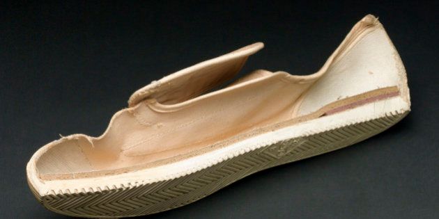 UNITED KINGDOM - OCTOBER 17: Sectioned white plimsoll, size 8, with cushioned insole, made by Dunlop. (Photo by SSPL/Getty Images)