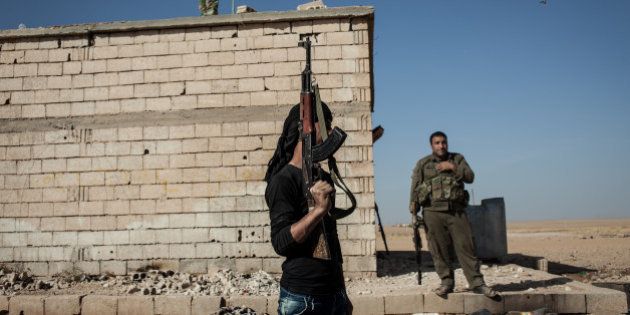 RAQQA COUNTRYSIDE, OCTOBER 17: Members of the Syrian armed group Liwa Thuwar al-Raqqa hold positions in the frontline against the Islamic State group outside Ayn al-Issa, in the countryside of Raqqa province.
