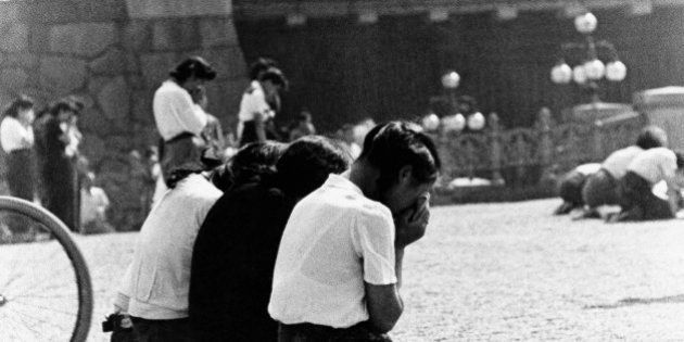 Schoolgirls weep in sorrow and shame in the Imperial Plaza before Emperor Hirohito's palace in Tokyo after there were informed of Japan's surrender, Aug. 15, 1945. Some officers of the Imperial Army committed harikiri in the plaza to atone for what they felt was a loss of face for themselves and their emperor. (AP Photo)