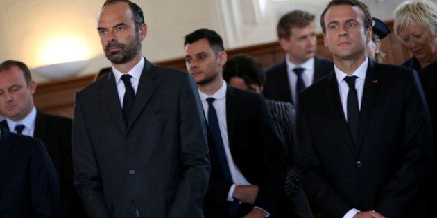 French Prime Minister Edouard Philippe (L) and French President Emmanuel Macron attend a mass to pay tribute to French priest Father Jacques Hamel one year after he was killed by Islamist militants in an attack in the church, in Saint-Etienne-du-Rouvray near Rouen, France, July 26, 2017. REUTERS/Charly Triballeau/Pool