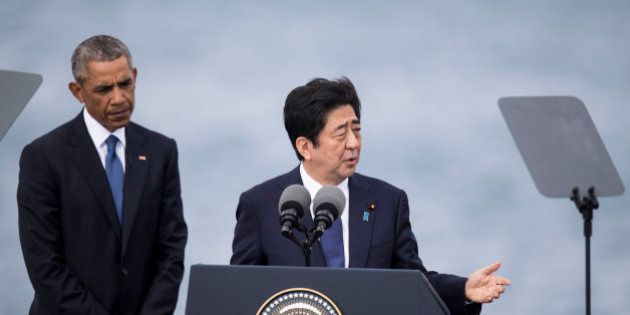 HONOLULU, HI - DECEMBER 27: U.S. President Barack Obama listens while Japanese Prime Minister Shinzo Abe delivers remarks at Joint Base Pearl Harbor Hickam's Kilo Pier on December 27, 2016 in Honolulu, Hawaii. Abe is the first Japanese prime minister to visit Pearl Harbor with a U.S. president and the first to visit the USS Arizona Memorial. (Photo by Kent Nishimura/Getty Images)