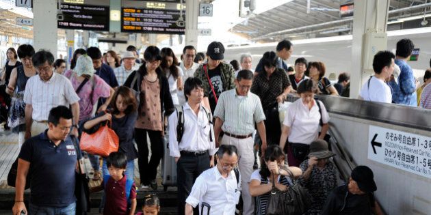 Thousands of holidaymakers return back to Tokyo by 'shinkansen', commonly known as the bullet train, at Tokyo station in the Japanese capital on August 14, 2011. Millions of Japanese make the traditional trek back to their hometowns from the cities during the 'Obon' holiday season every mid-August to follow the Buddhist custom of honoring the spirits of their ancestors, visiting family graves. AFP PHOTO / TOSHIFUMI KITAMURA (Photo credit should read TOSHIFUMI KITAMURA/AFP/Getty Images)